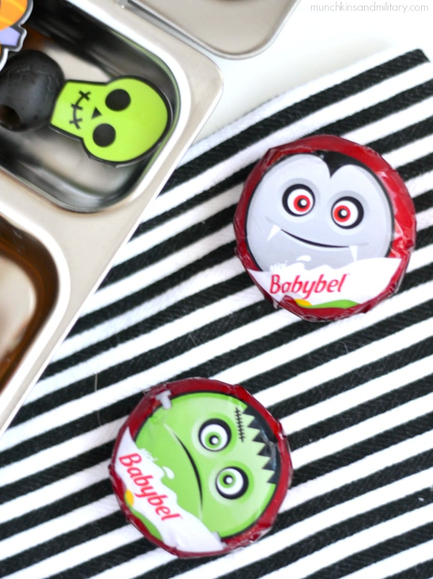Mini Babybel Halloween cheeses on striped background