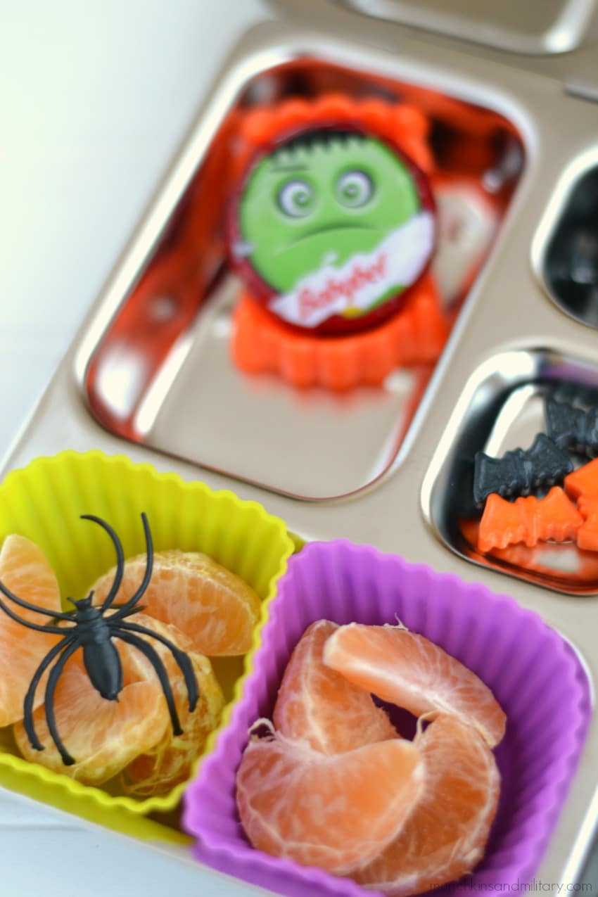 Healthy bento snack idea for Halloween - orange slices with a spider and frankenstein mini cheese