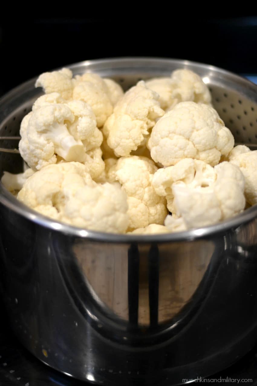 Easy creamy mashed cauliflower recipe - starts with florets in a steaming basket