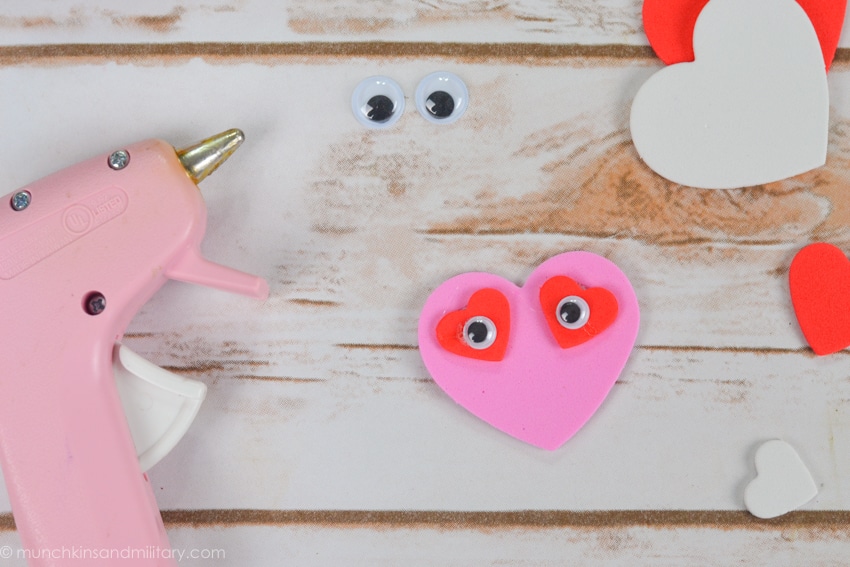 DIY Valentine's treat craft supplies - pink glue gun, googly eyes, pink and red foam hearts