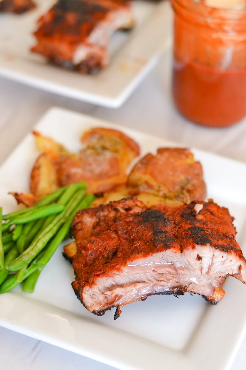 Tender and juicy ribs right off the grill with smashed potatoes, green beans, and guava bbq sauce