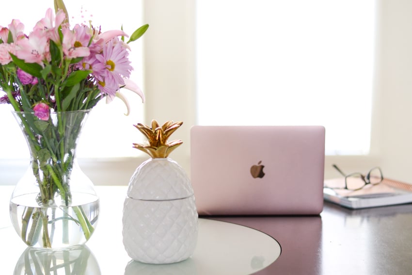 Pink MacBook and pineapple cookie jar