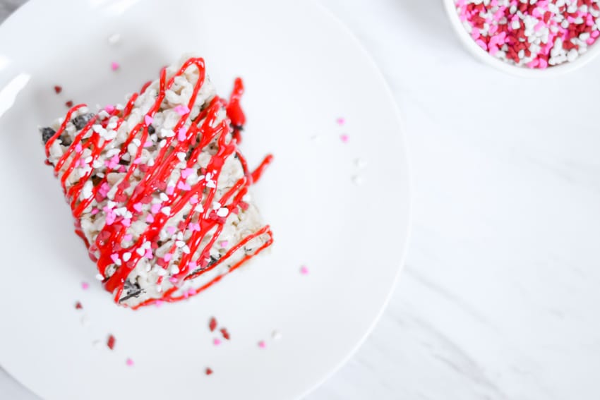 Oreo Krispies Treats decorated with red icing and heart sprinkles for Valentine's Day