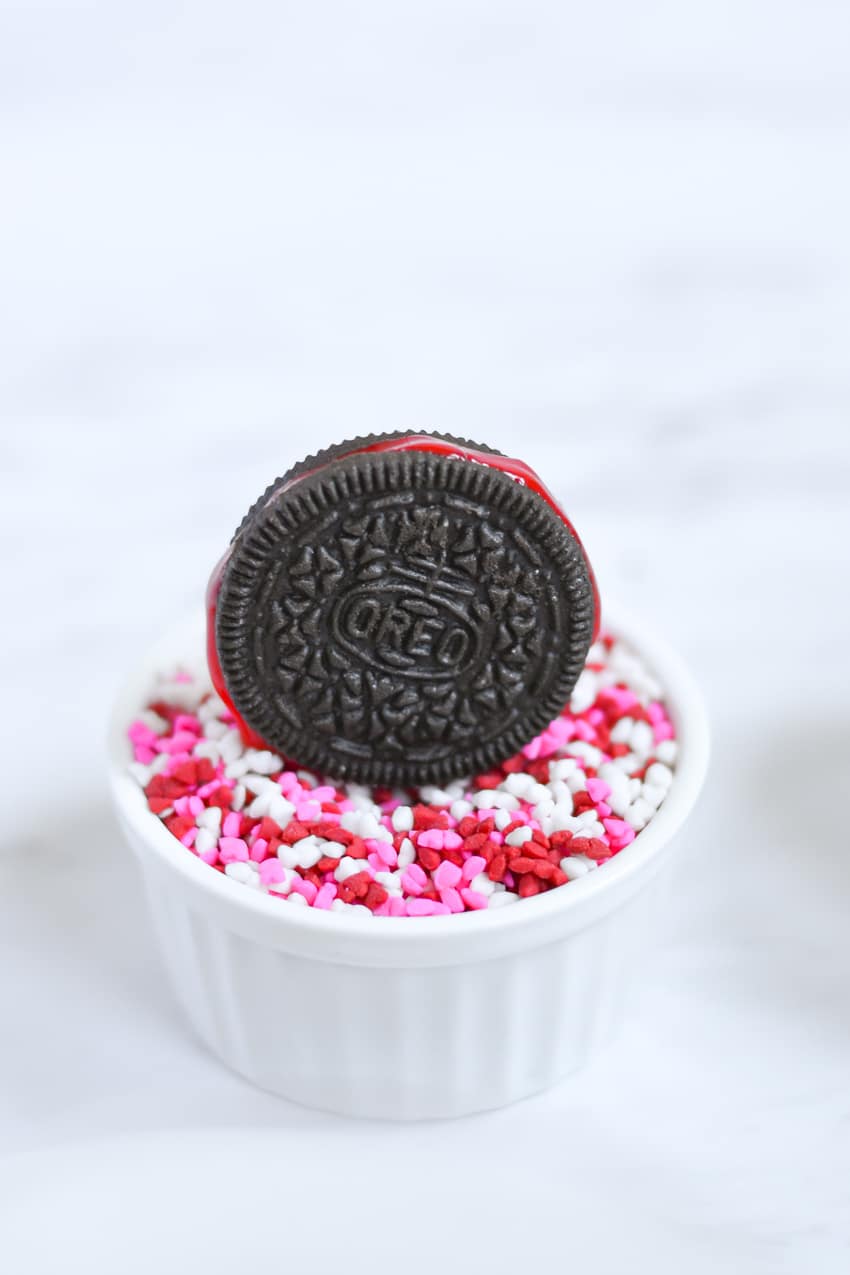 Dip Oreo cookies in sprinkles for a festive holiday upgrade