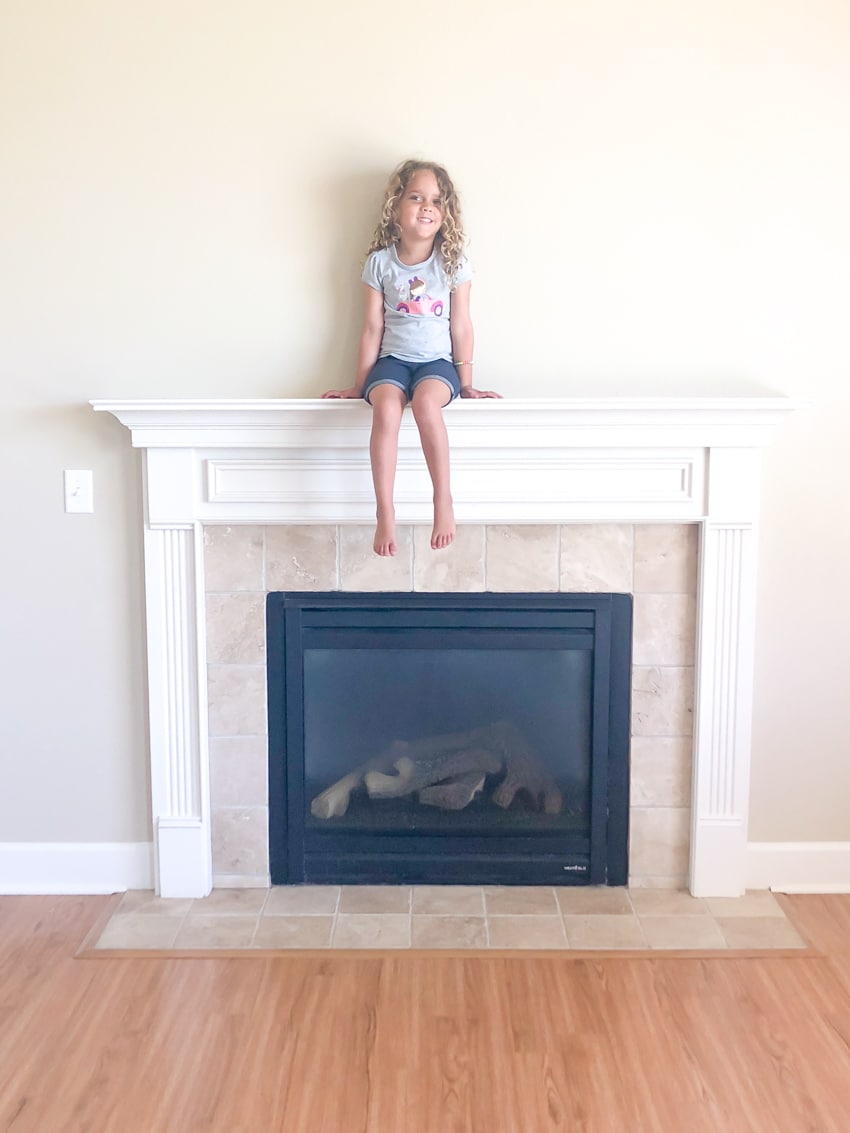 Fort Riley housing- little girl sitting on fireplace mantel
