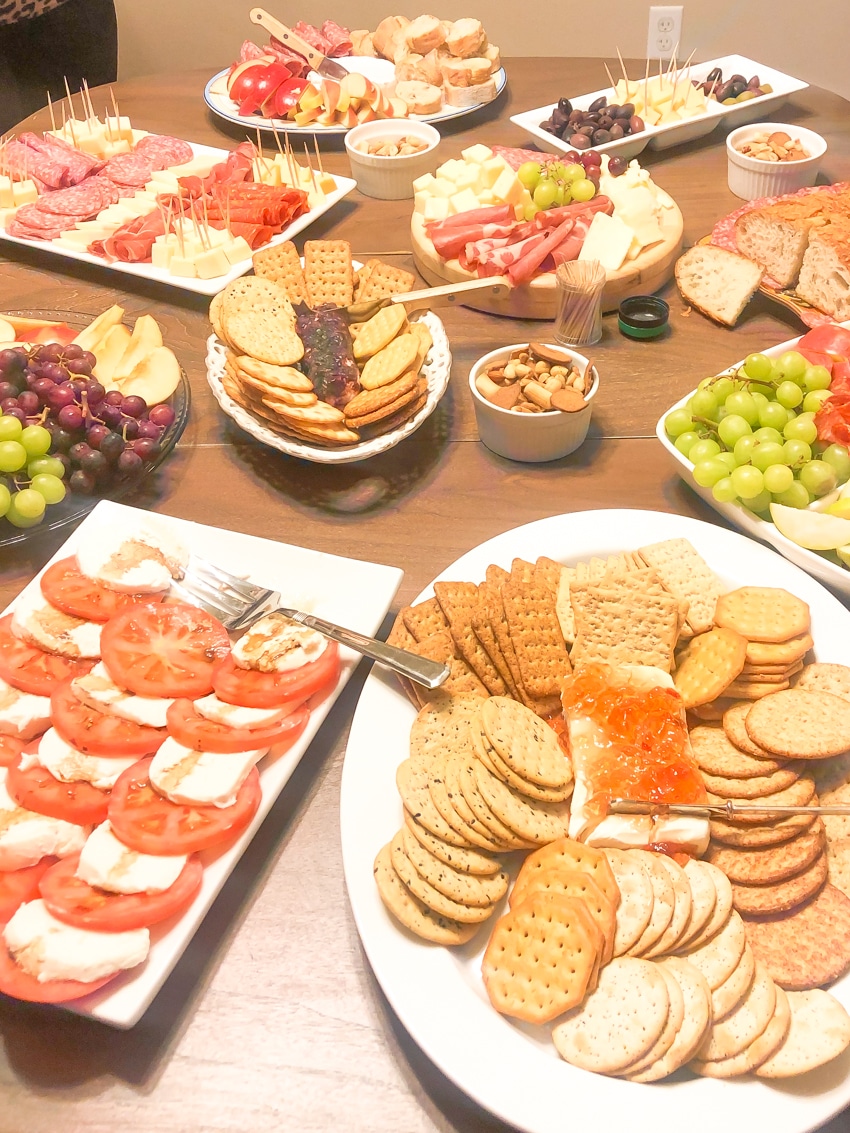 Charcuteri foods spread across wooden table