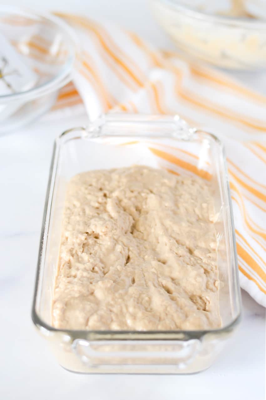 Guinness beer bread batter in a glass loaf pan