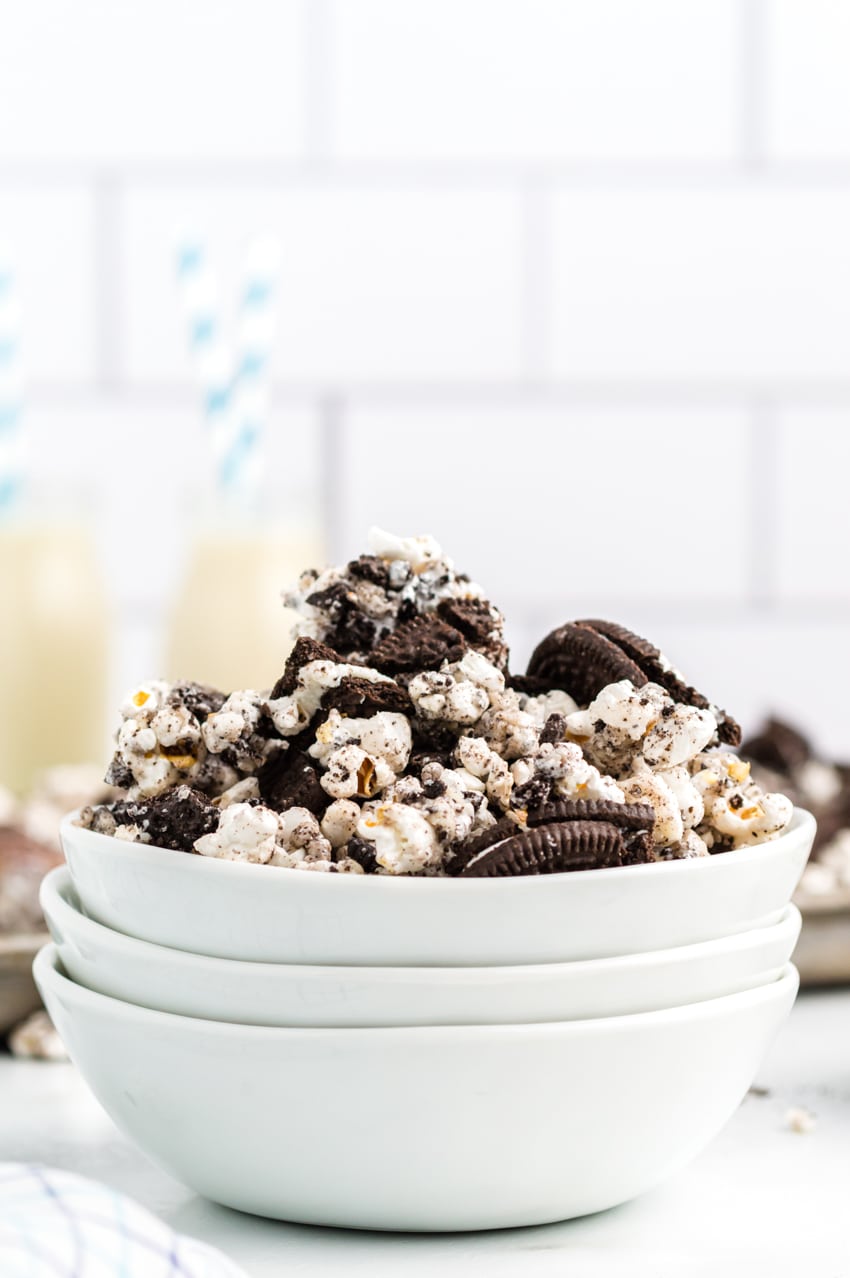 Close up of oreo popcorn in a stack of white bowls.