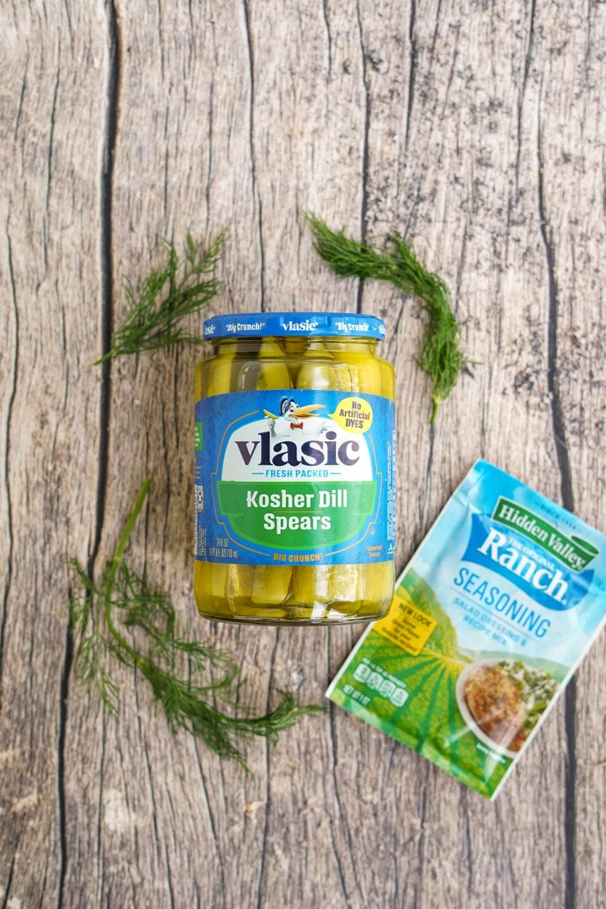 jar of vlasic pickles and hidden valley ranch packet on wood background