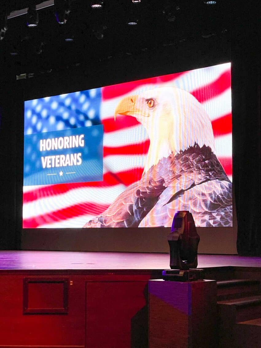 A slideshow presentation featuring the American flag and a bald eagle, aboard the Carnival Sunrise's military veteran appreciation gathering
