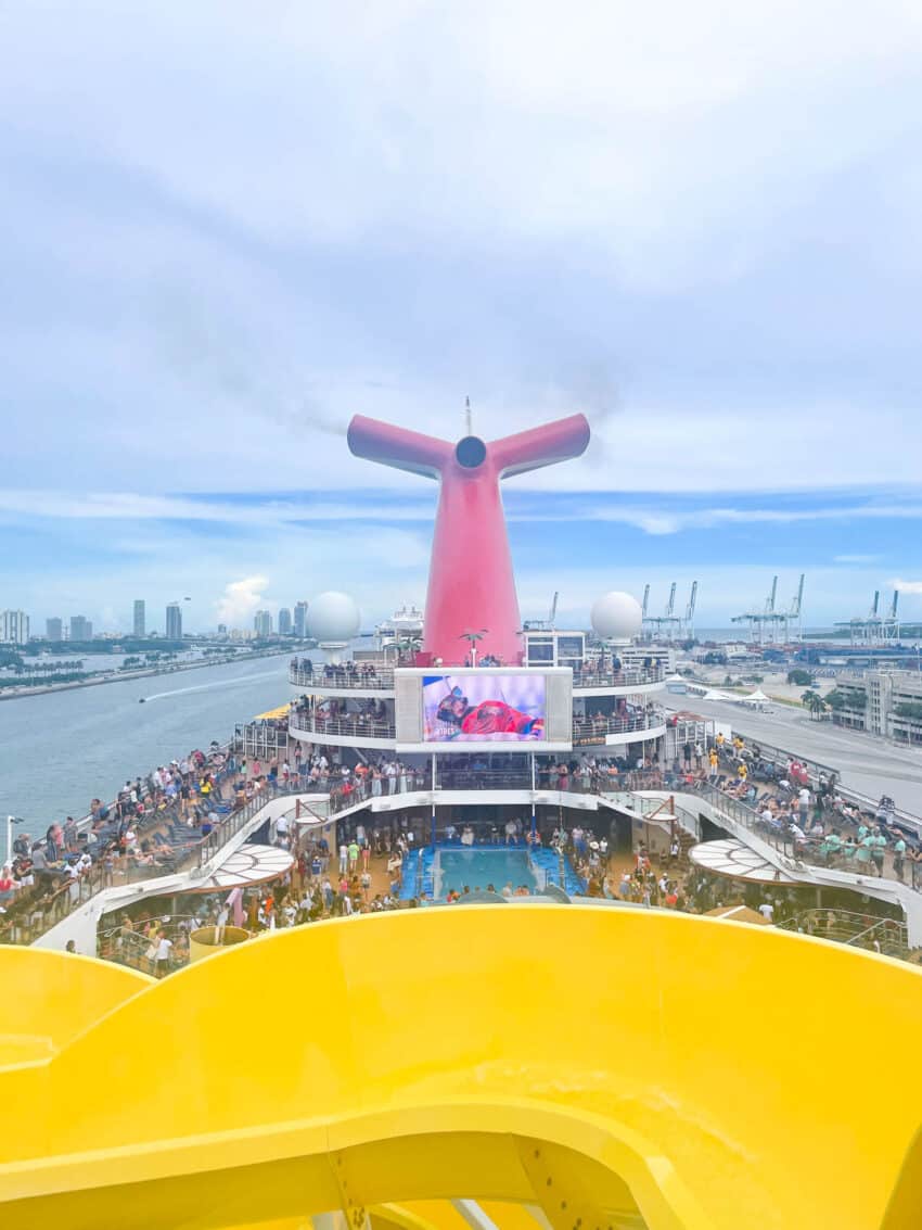 Embarkation from Miami aboard the Carnival Sunrise cruise ship. A View of the iconic Carnival "whale tail" and. a yellow slide. 