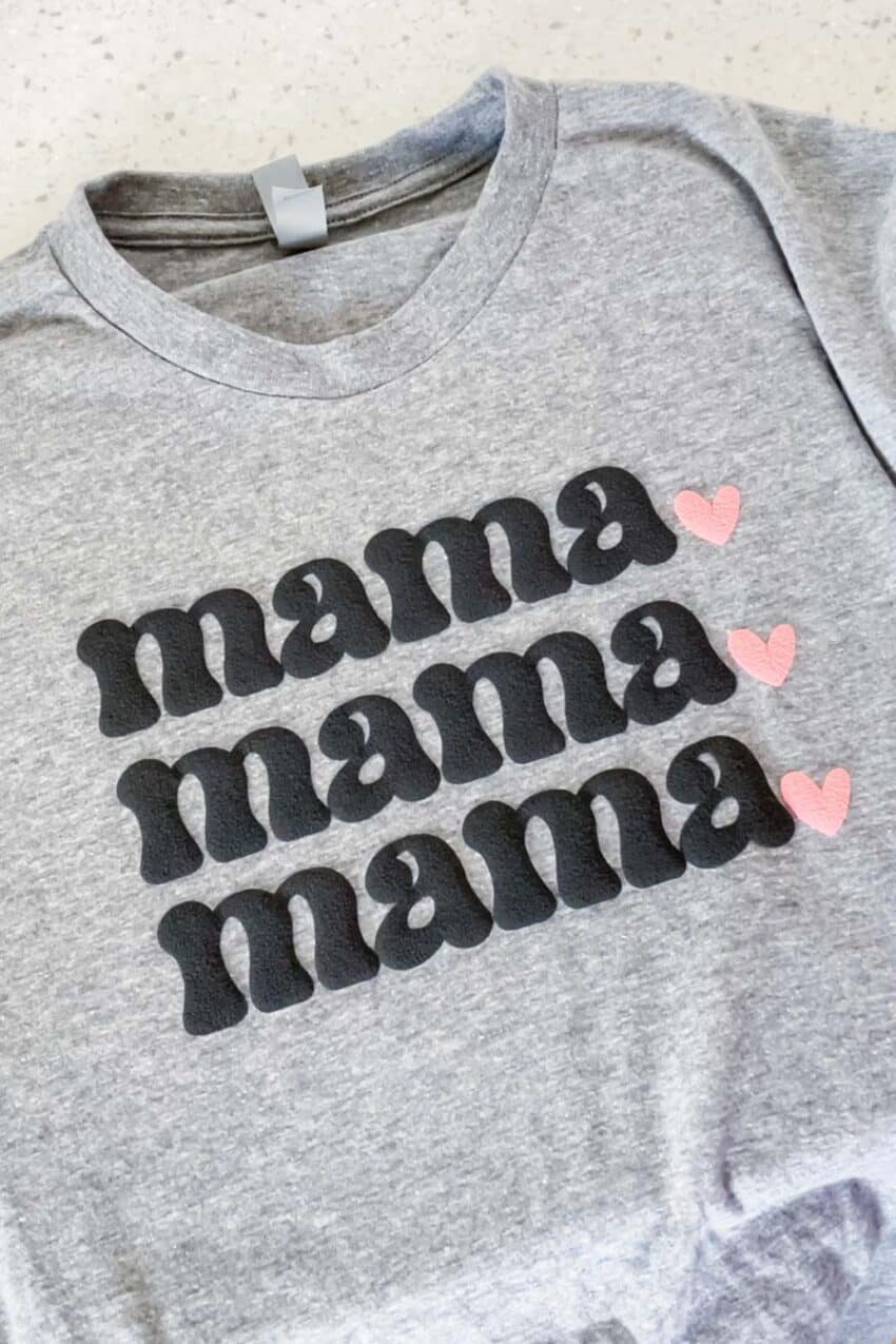 Grey t-shirt with the words mama three times, followed by 3 pink hearts