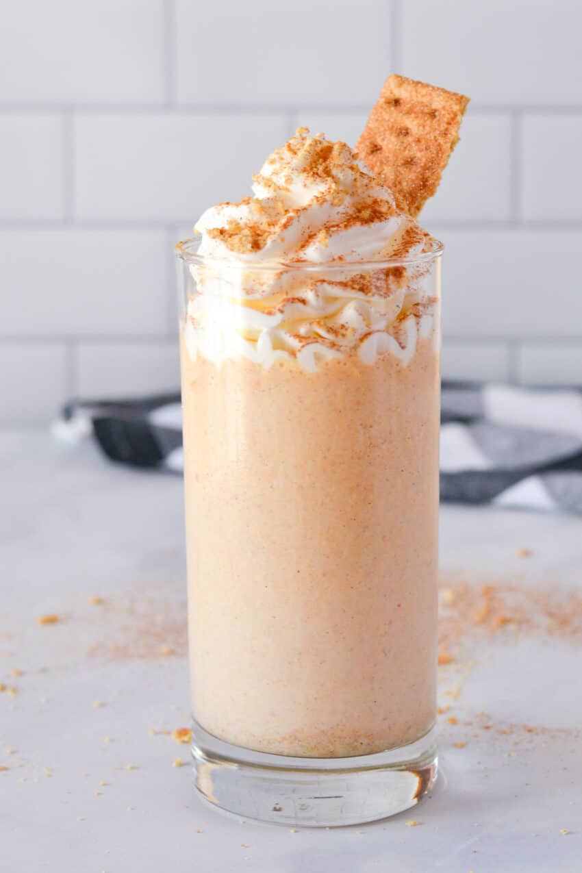 Glass of pumpkin spice milkshake topped with whipped cream